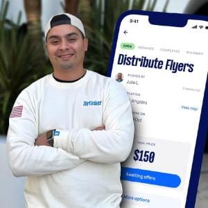Martin De Anda standing in front of a white wall with his arms crossed, wearing an Airtasker sweatshirt