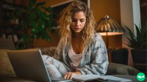 A young woman looking budget while sitting on a couch near her coffee table.